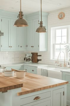 a kitchen with blue cabinets and wooden counter tops