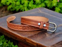 ➤Fully handmade western cowboy leather belt ➤ Stainless Steel Buckle ➤Tooled embossed design ➤Custom engraving option ➤ Single Piece Leather ➤100% full grain genuine leather ➤ Easy Snap System for Interchanging Buckles ➤ 1.5" WIDE ➤Belt thickness 3.2 mm - 1/8" thickness ➤Returns accepted within 30 days of receiving item (custom engraved beltscannot be returned) Tooled Western Floral Engraved Leather Belt for Men 100% Genuine Full Grain Cowhide with Snaps 1-1/2" WIDE Personalized Belt that serves as a great gift for your loved one. You can choose to personalize this belt, making it an Engraved Belt. This is a handmade western leather belt. Engraved Leather Western Belt, Western Style Engraved Leather Belt, Western Belt Buckles For Rodeo, Western Leather Belt Buckles For Rodeo, Hand Tooled Leather Belts For Western-themed Events, Western Leather Belts And Suspenders With Antique Buckle, Western Leather Belts And Suspenders With Concho, Western Leather Belt For Western-themed Events, Adjustable Leather Western Belts And Suspenders