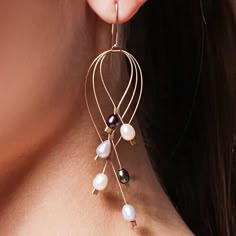 A full size version of Meghan's popular Lattice earrings, featuring six pearls in a variety of colors suspended from gracefully crossing wire arcs. Just the right combination of artful, edgy, and comfortable. So lightweight you'd forget you have them on, but all the compliments will remind you. Made of durable fine steel cable decorated with freshwater pearls in metallic colors and silver accents. All components are hypoallergenic. Length 3.25". Made in USA. Designer details → Wire Cuff Earrings, Pearl Wire Earrings Diy, Freshwater Pearl Earrings Diy, Flat Wire Jewelry, Diy Wire Jewelry For Beginners, Diy Earrings Pearl, Hammered Wire Jewelry, Diy Earrings Dangle, Silver Wire Jewelry