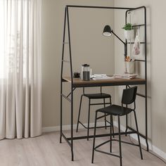 a table with four chairs and a mirror in the corner, next to a window