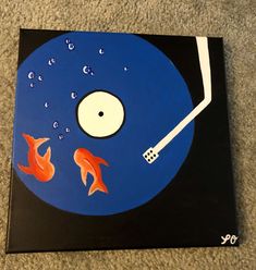 a blue disk with orange fish on it