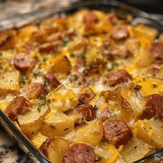 a casserole dish with potatoes, ham and cheese