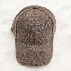 a brown hat sitting on top of a white rug