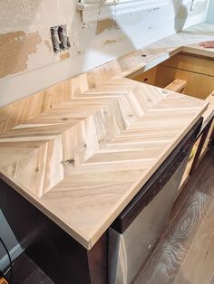 an unfinished kitchen counter is being worked on by a woodworker in the process