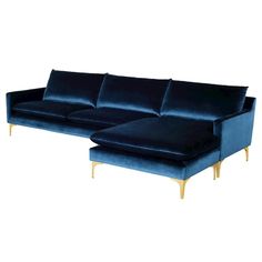 a blue velvet couch with gold legs and footstools on an isolated white background