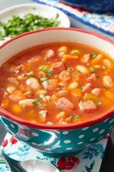 a bowl of soup with beans and meat in it