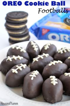 chocolate footballs are on a plate with oreos and cookies in the back ground