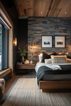 a bedroom with stone wall and wooden ceiling, along with two framed pictures on the wall