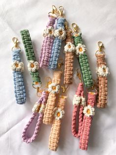 several crocheted key chains with flowers on them