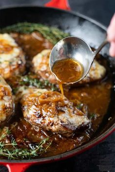 someone is pouring sauce on some meat in a skillet