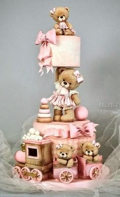 there is a teddy bear on top of the cake with other bears sitting around it