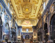 the interior of an old church with gold painted ceilings