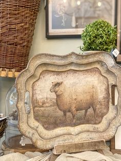 there is a sheep painting on the side of this table in front of a basket