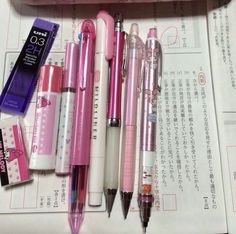 several pens are lined up on top of a piece of paper