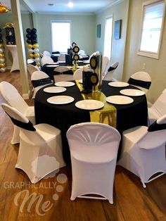 a banquet room with black and white tablecloths, gold accents and balloons on the walls