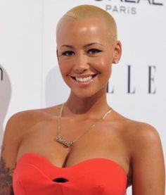 a woman in a red dress smiling at the camera