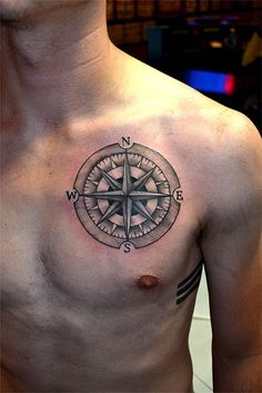 a man with a compass tattoo on his chest