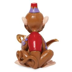 a ceramic figurine of a mouse sitting on the ground