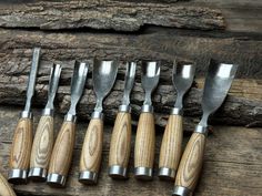 seven wood carving tools lined up on top of each other