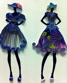 two paper dolls are standing next to each other