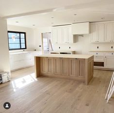 an empty kitchen with white cabinets and wood flooring is seen on the instagram page