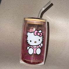 a hello kitty tumbler with a straw in it