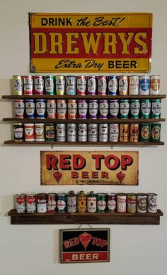 two shelves with beer cans and signs on them