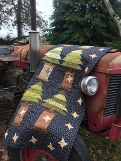 an old tractor with a quilt on it