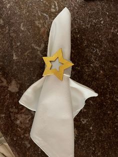 a napkin with a gold star on it sitting on top of a marble countertop