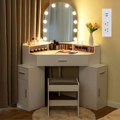 a white vanity with lights on it and a stool in front of the mirror that is lit up