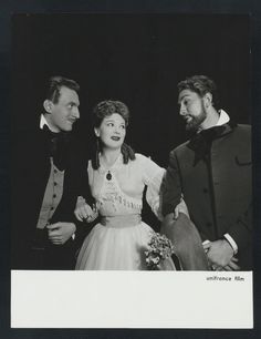 an old black and white photo of two men and a woman