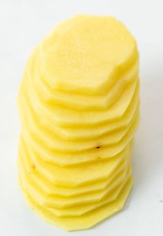 a stack of yellow cake sitting on top of a white table