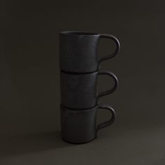 three black cups stacked on top of each other