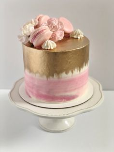 Pink cake with gold painted on top and down the sides, topped with macarons, meringues and flowers. Pink Cake With Macarons, Birthday Cake With Macarons On Top, Cakes With Macarons On Top, Gold Ombre Cake, Cake With Macarons On Top, Macaron Cakes, Cake With Gold, 11 Birthday