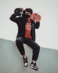 a man with a skateboard on his head is sitting on the edge of a wall