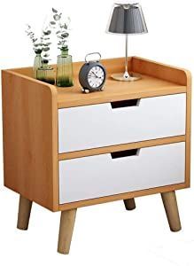 a night stand with two drawers and a clock on it, next to a lamp