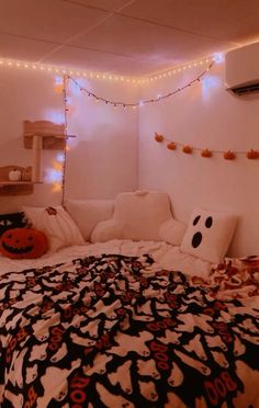 a bed with halloween decorations and lights on the wall