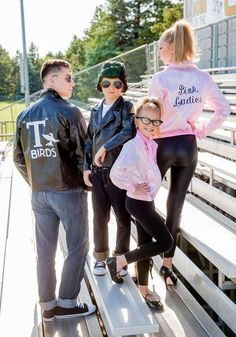 a group of people standing on top of a bleachers