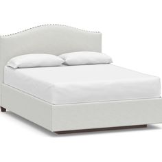 a bed with white linens and pillows on top of the headboard, in front of a white background