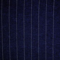 a close up view of a blue suit with pinstripe pattern