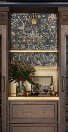 a wooden cabinet filled with lots of glassware