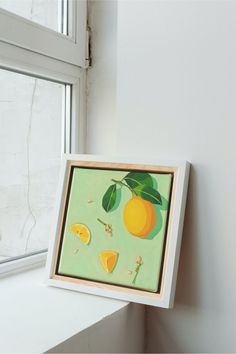 a painting hanging on the side of a window sill next to a white wall