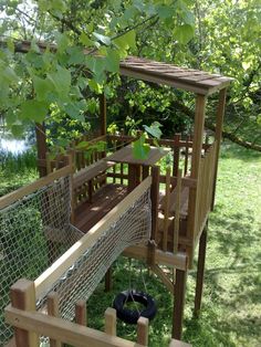 a small wooden structure in the middle of some grass