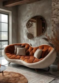 a living room with a couch, mirror and rugs on the floor in front of it