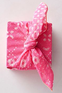 a pink and white flowered wrapper with a knot on it's end