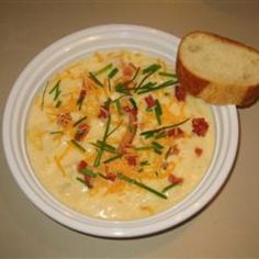 a bowl of soup with bread on the side