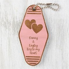 a wooden keychain with two hearts and the words, dancing & keeping keys to my heart on it