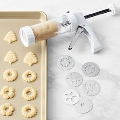 the cookie cutters are next to some doughnut holes on a baking sheet,