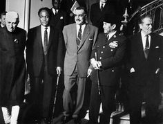 a group of men in suits and ties standing on steps with one holding a cane