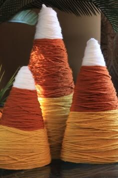 three different colored cones sitting on top of a shelf next to pictures and framed photos